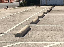 Placement of multiple wheel stops in parking lot in West Memphis, Arkansas